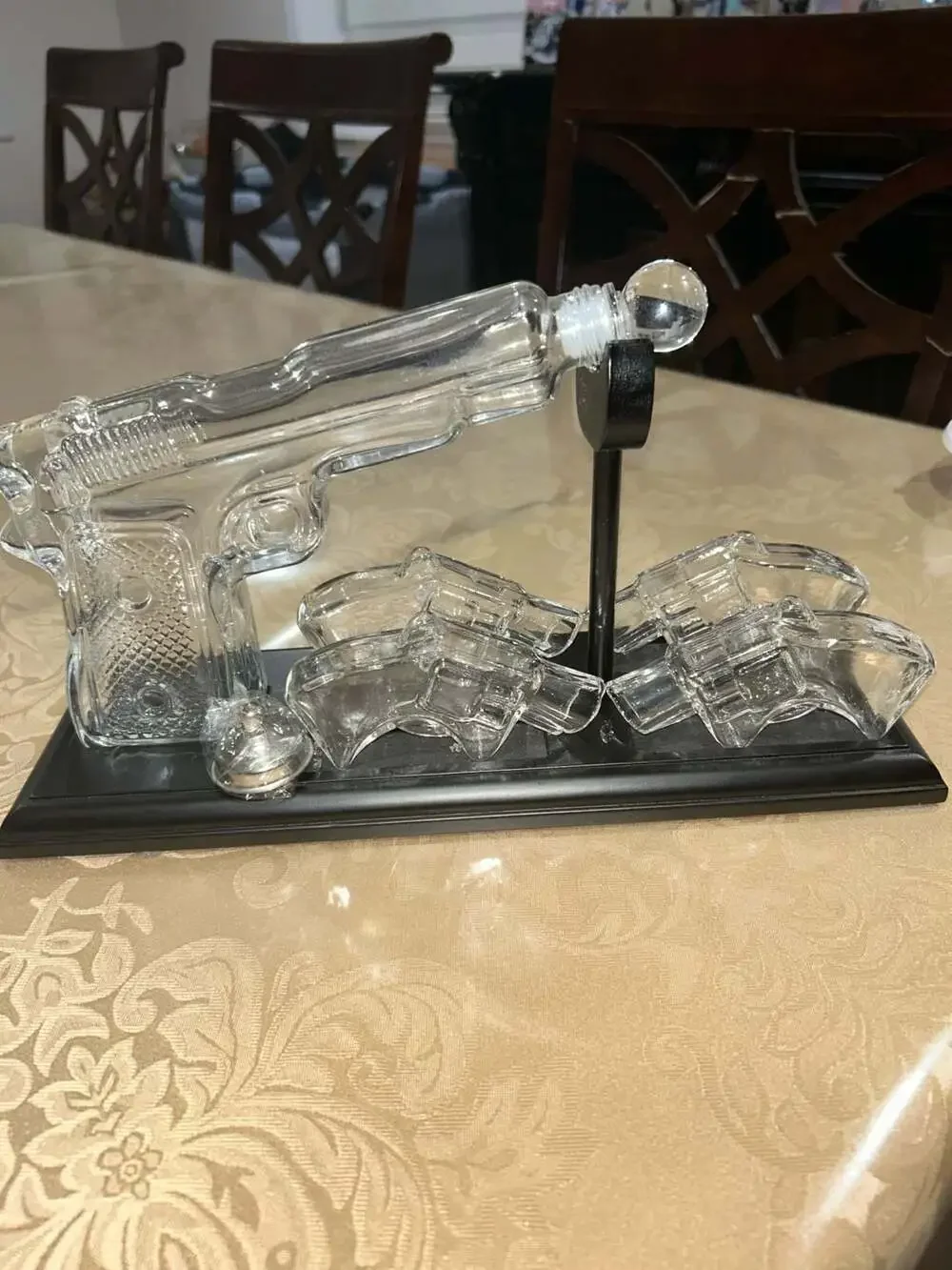 Clear Glass Pistol Decanter Set with Four Glass Shot Glasses on Display Stand